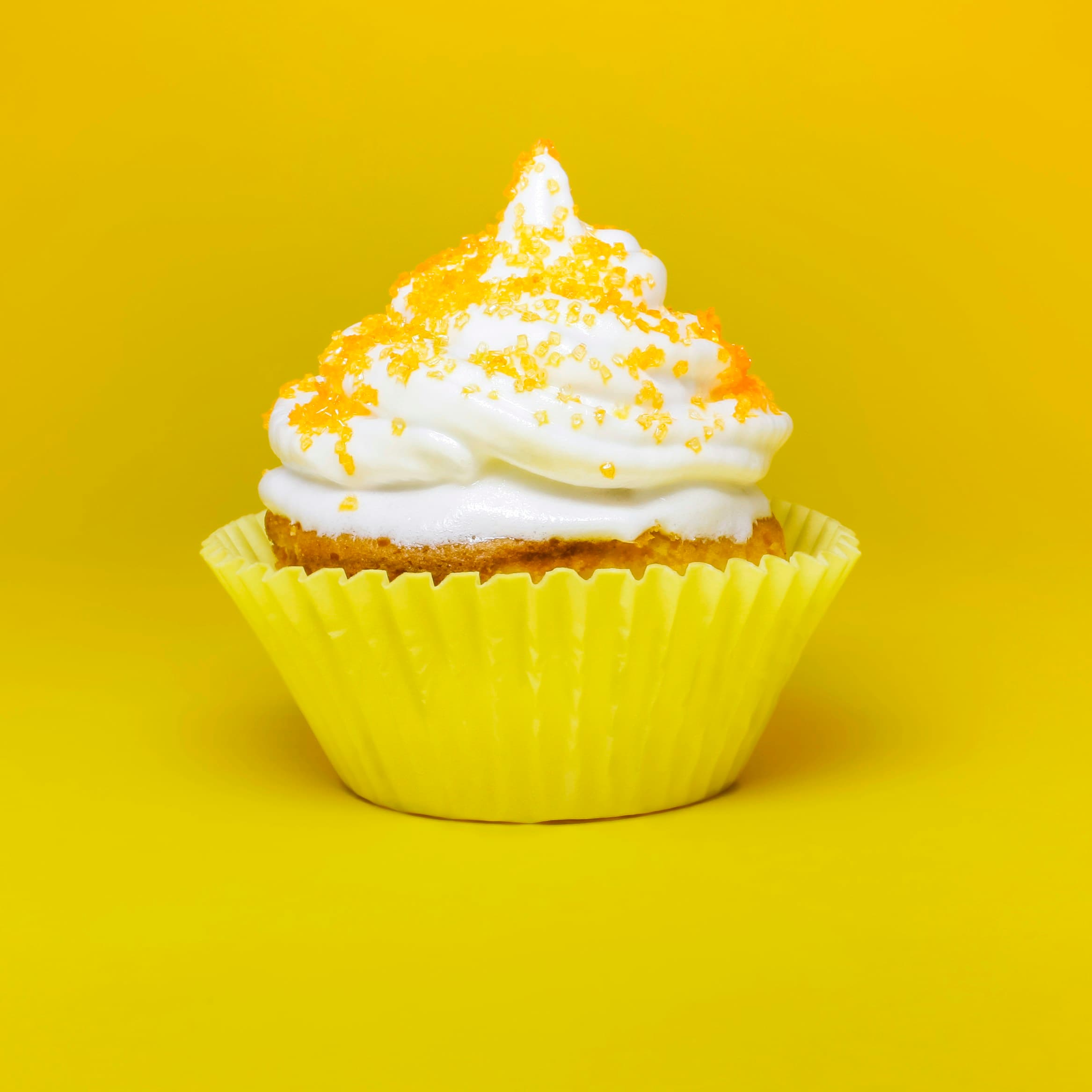 Cupcake with cream frosting in a yellow case