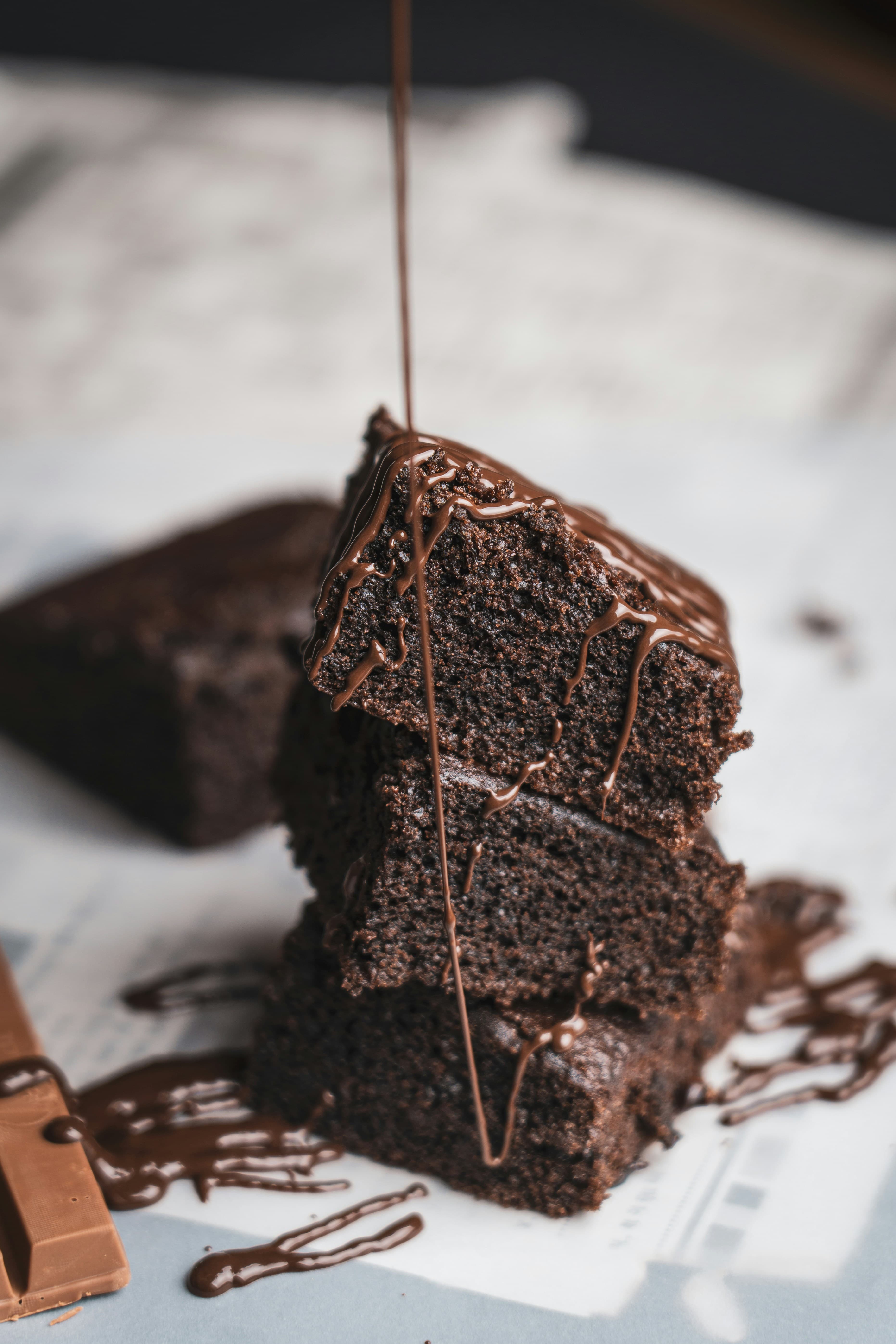 Stack of chocolate brownies with chocolate sauce
