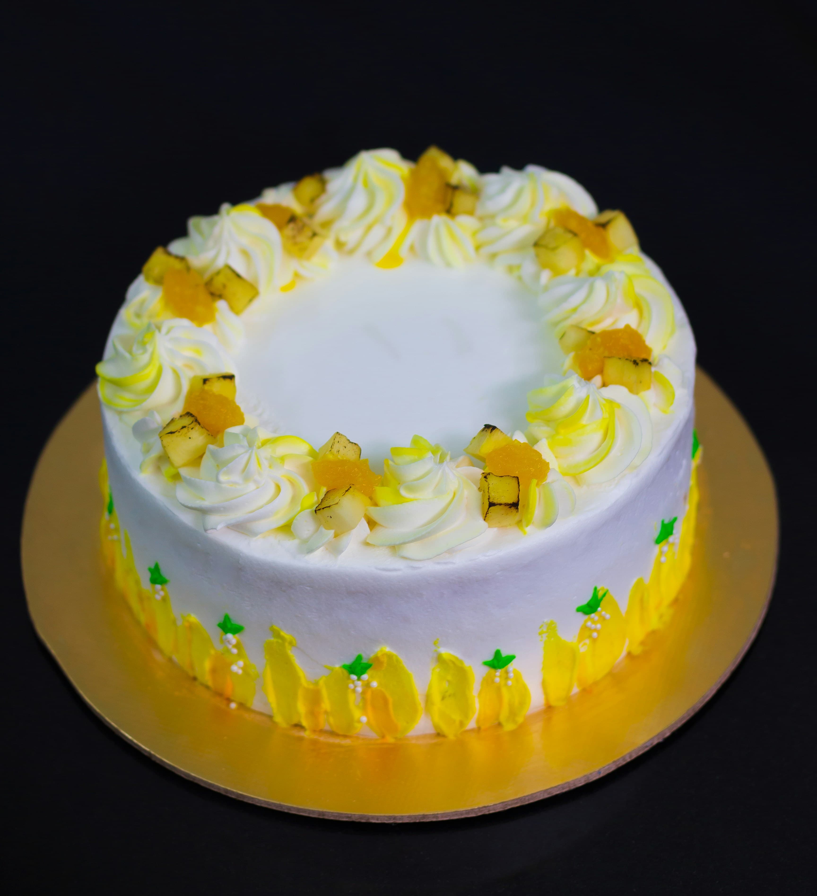 Cream cake decorated with pineapple pieces