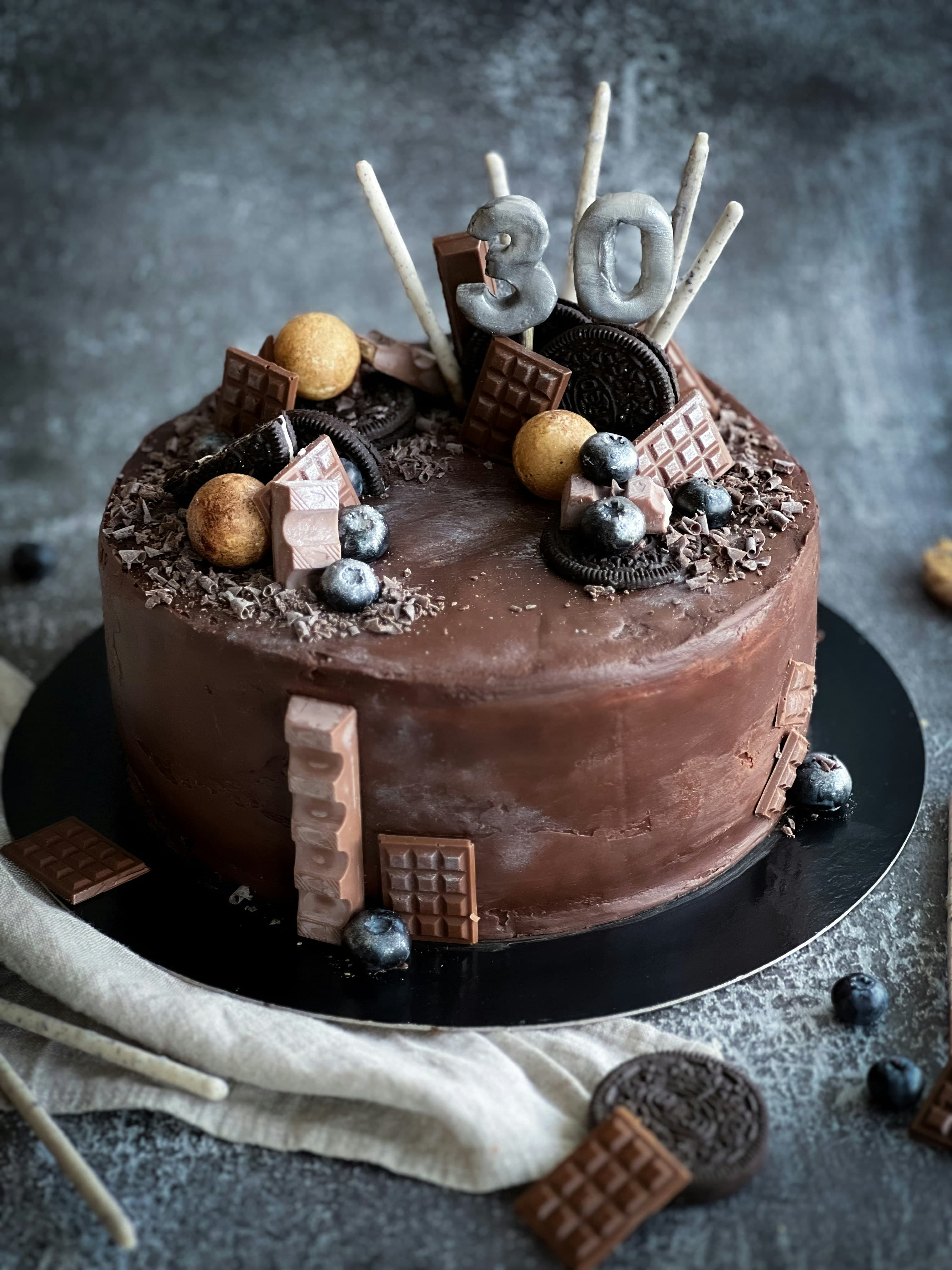 Chocolate cake topped with chocolates and wafers